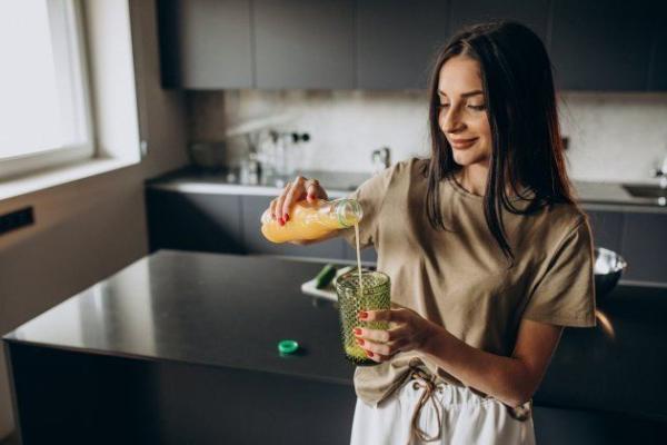young-woman-drinking-juice-home